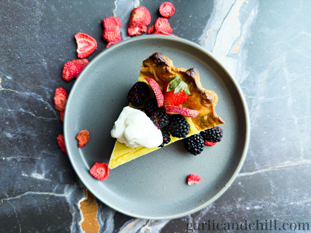 Vegan Berry-Cherry Lemon Custard Pie on plate with fresh berries