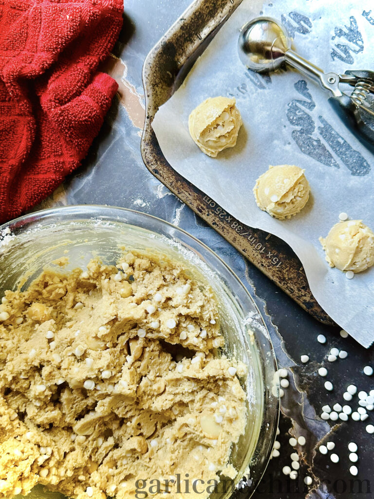 Vegan Salted White Chocolate Macadamia Cookie dough balls on baking sheet