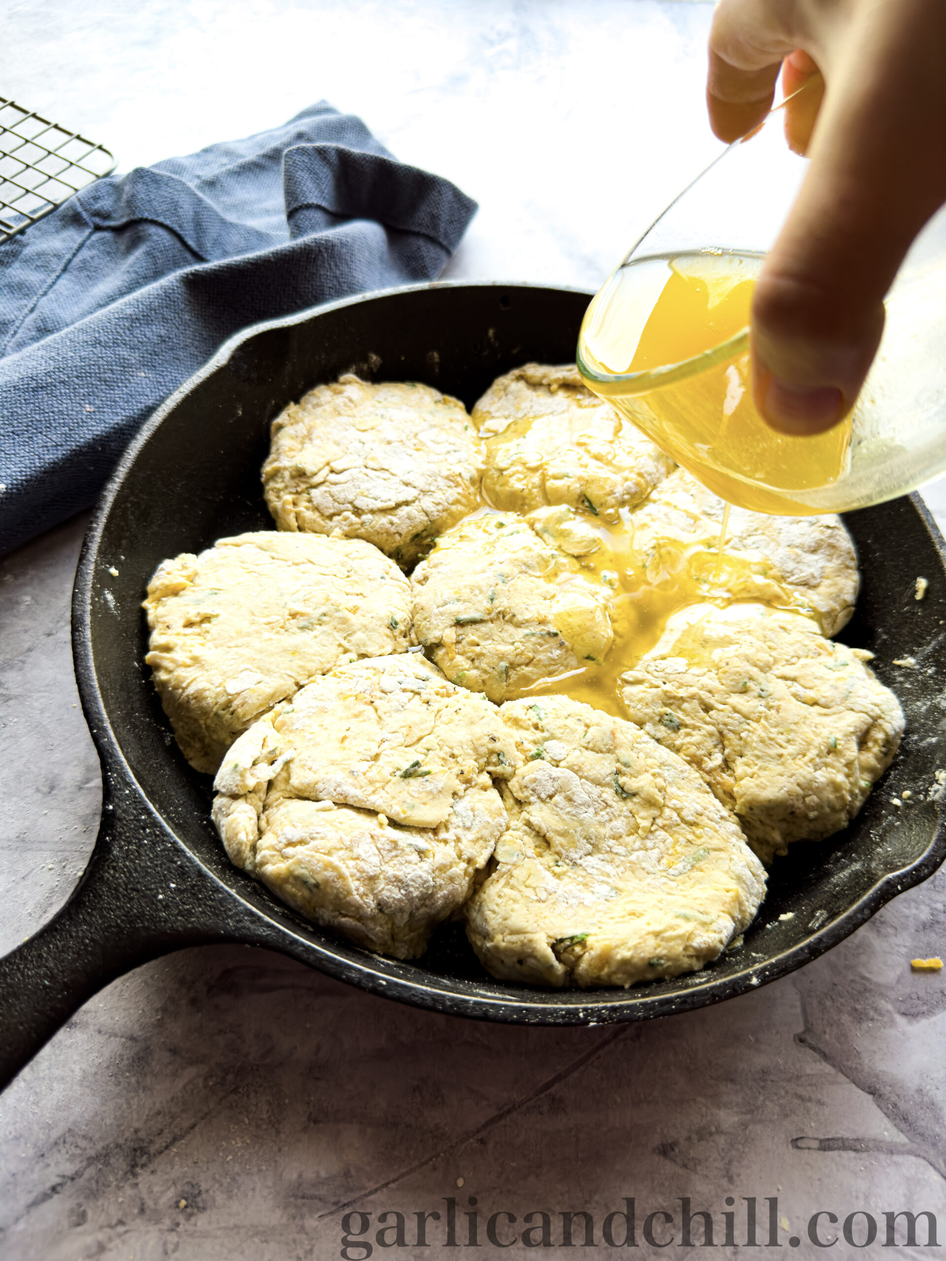 Pouring Vegan Melted Butter over Biscuits