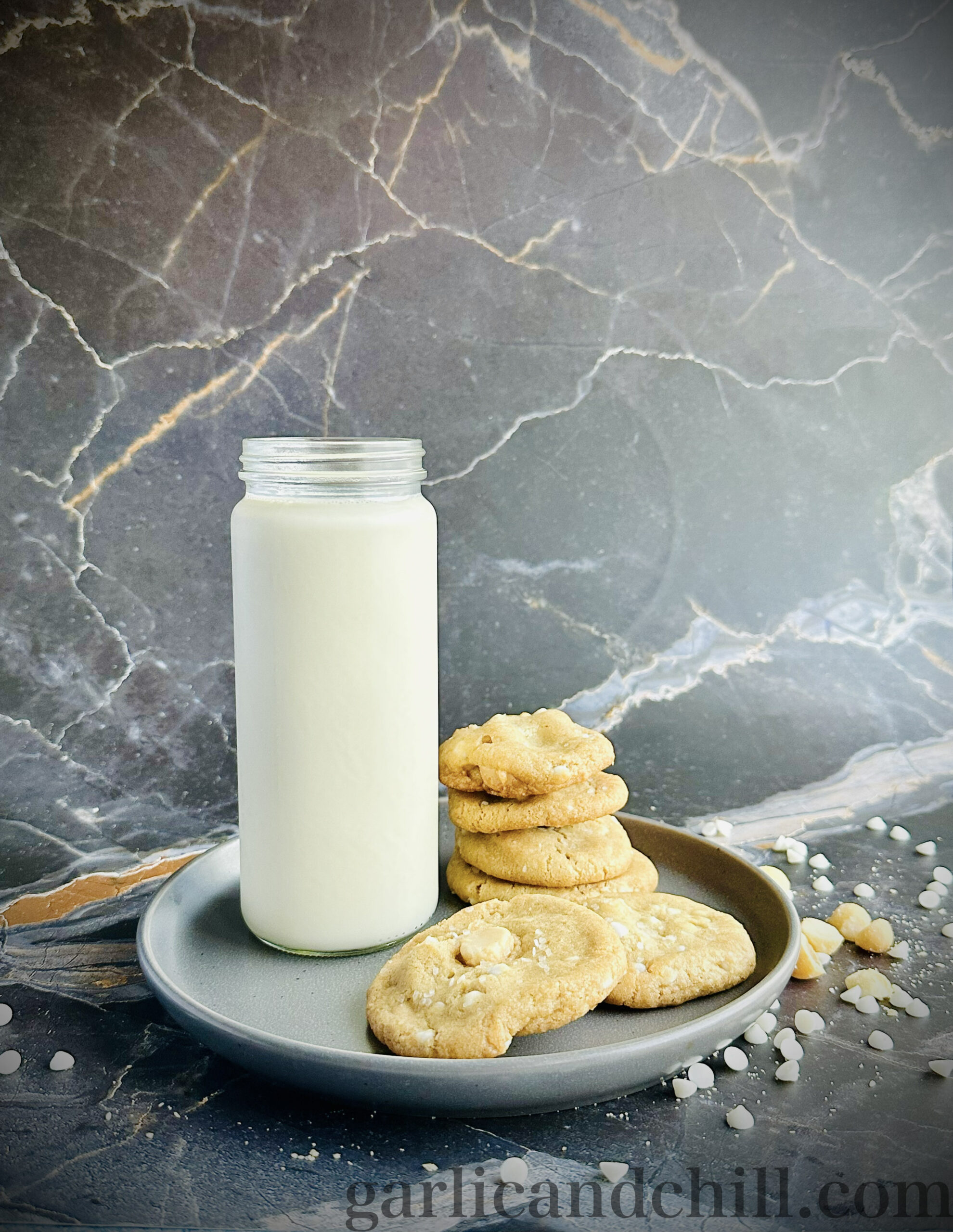 Vegan White Chocolate Macadamia Cookies with glass of oat milk