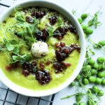 Vegan Fresh Pea Shoot Soup w/ Bac'n Oil in bowl with toppings