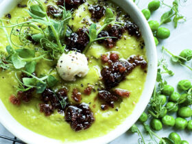 Vegan Fresh Pea Shoot Soup w/ Bac'n Oil in bowl with toppings