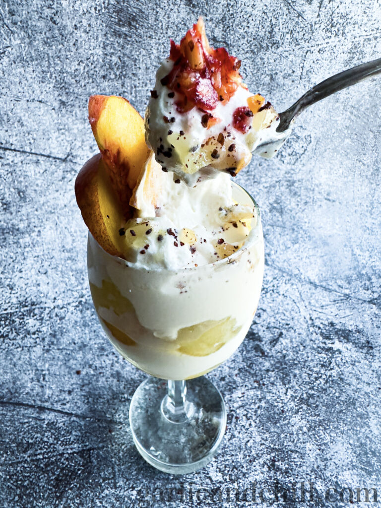 Creamy ‘n’ Tangy Kiwi-Peach Summer Parfait ingredients in glass w/ spoon