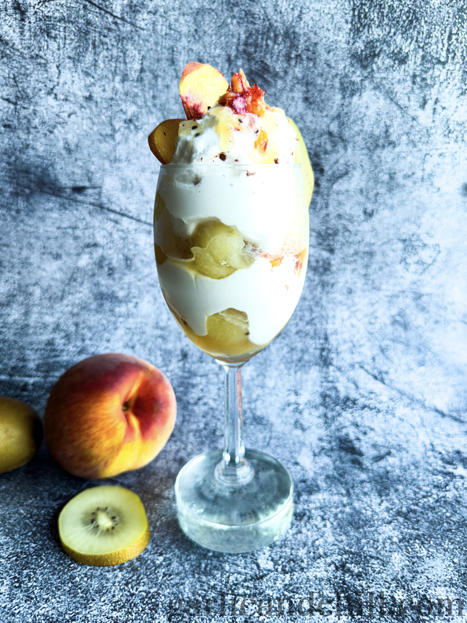 Creamy 'n' Tangy Kiwi-Peach Summer Parfait in glass (front)